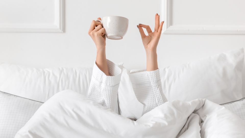 woman drinking coffee in the morning starting the day with a boost in your skincare
