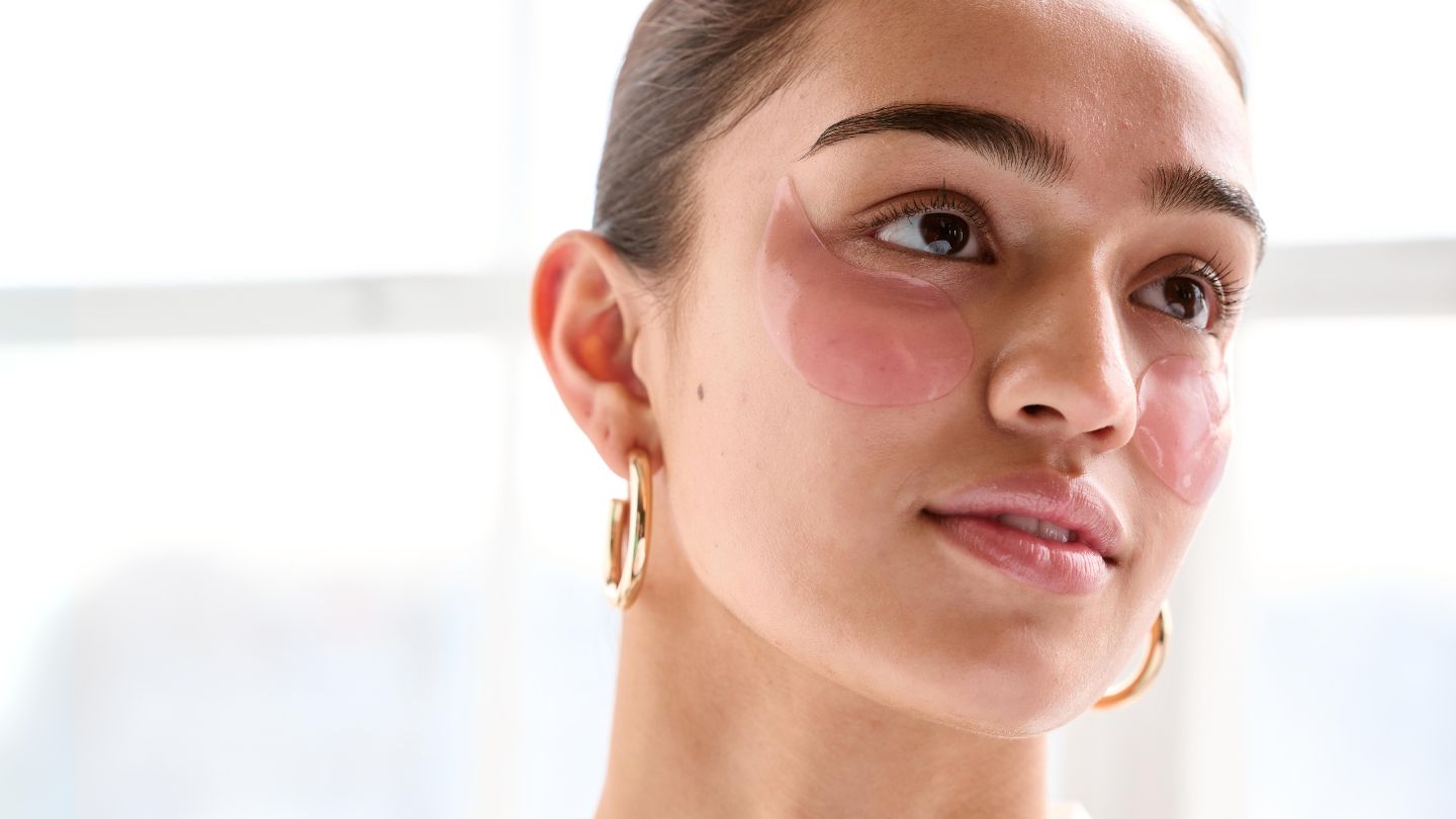woman wearing rose eye patches smoothing nourishing eye care