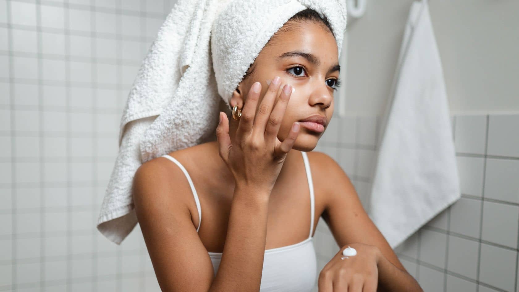 Woman applying facial cream