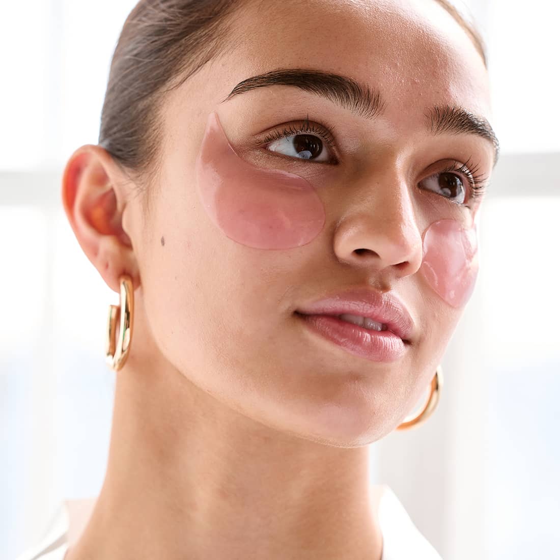 woman wearing firming hydrating rose eye masks pre-makeup eye patches