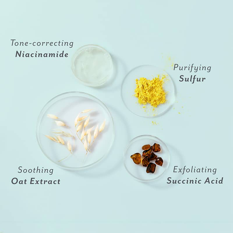 Ingredients used in skincare products displayed in small glass bowls on a light blue background.