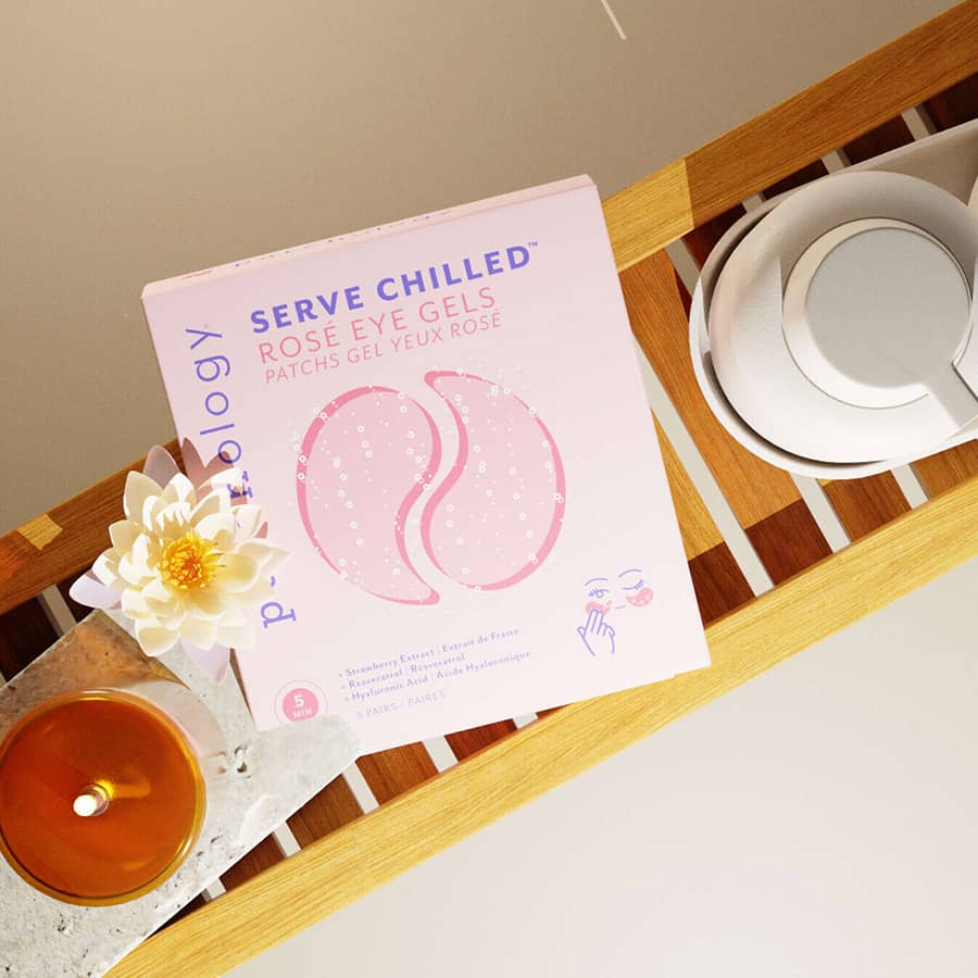 Box of Serve Chilled Rose Eye Gels on a wooden surface with a candle and flower in a bathroom