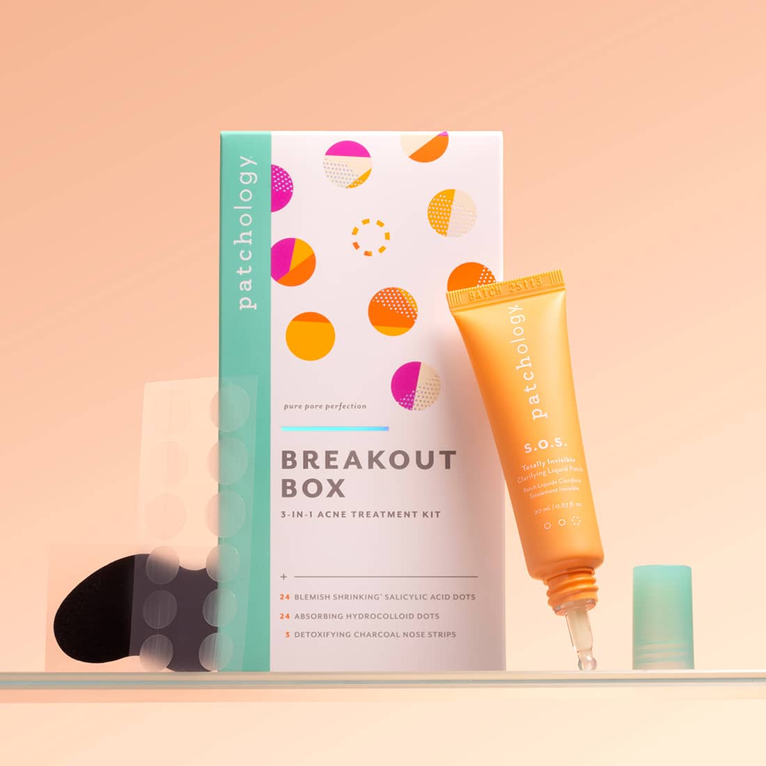 Patchology breakout box and sos pimple treatment kit on a peach background