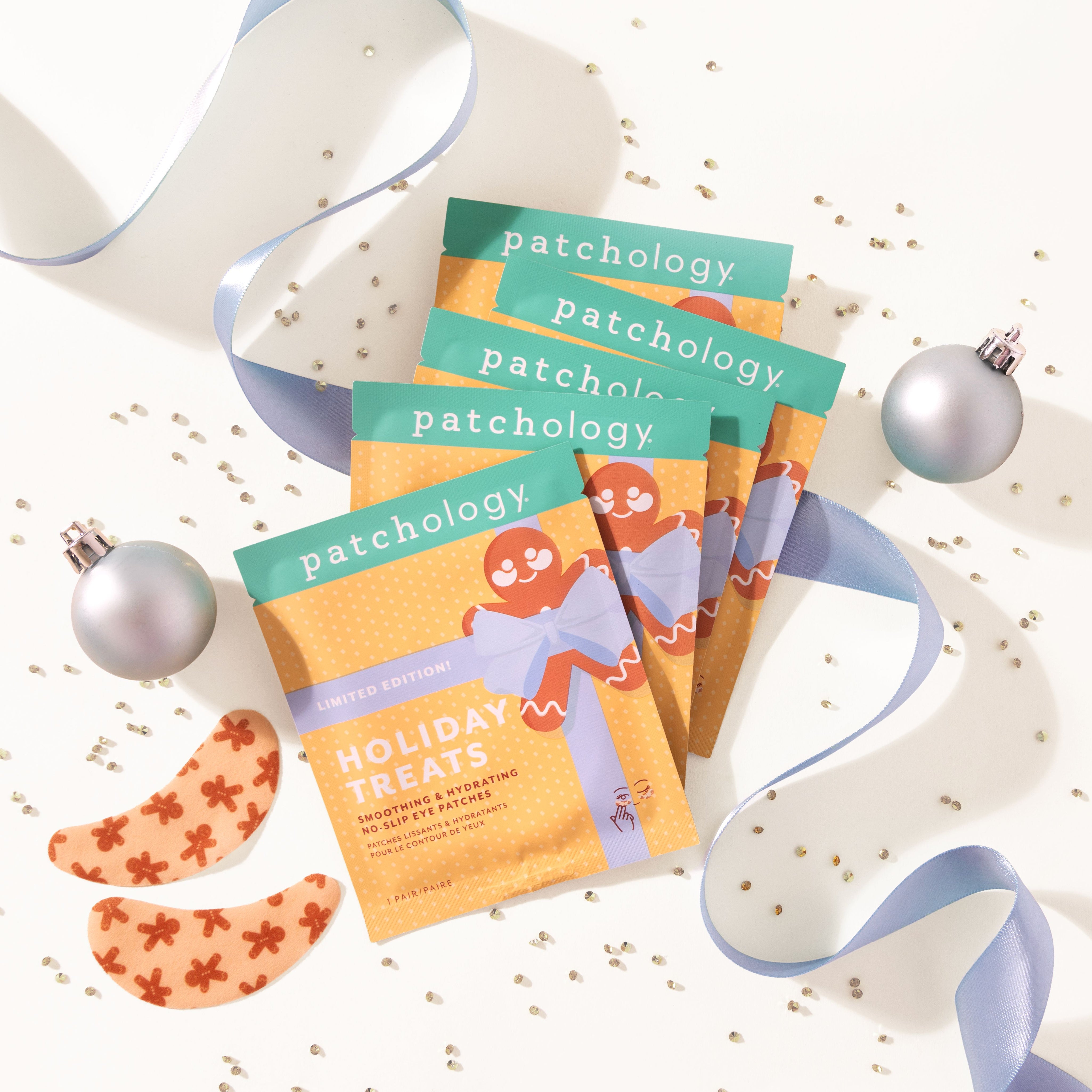 Patchology holiday-themed skincare product packaging with ribbons and ornaments on a white background