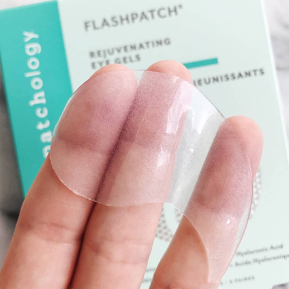 Patchology FlashPatch rejuvenating eye gel held on fingertips, clear hydrogel texture for under-eye skincare treatment