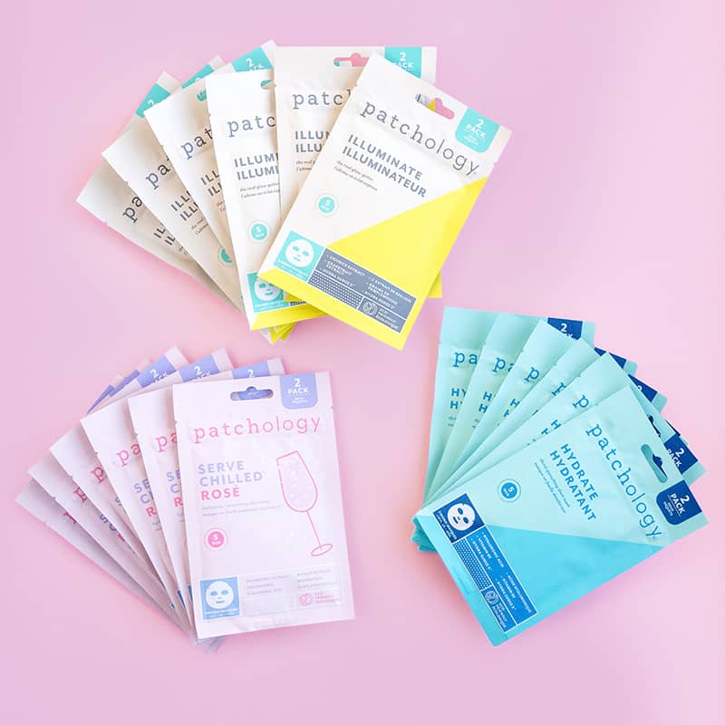 Collection of Patchology face mask packages on a pink background