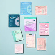 Collection of eye mask and face mask packages on a light blue background