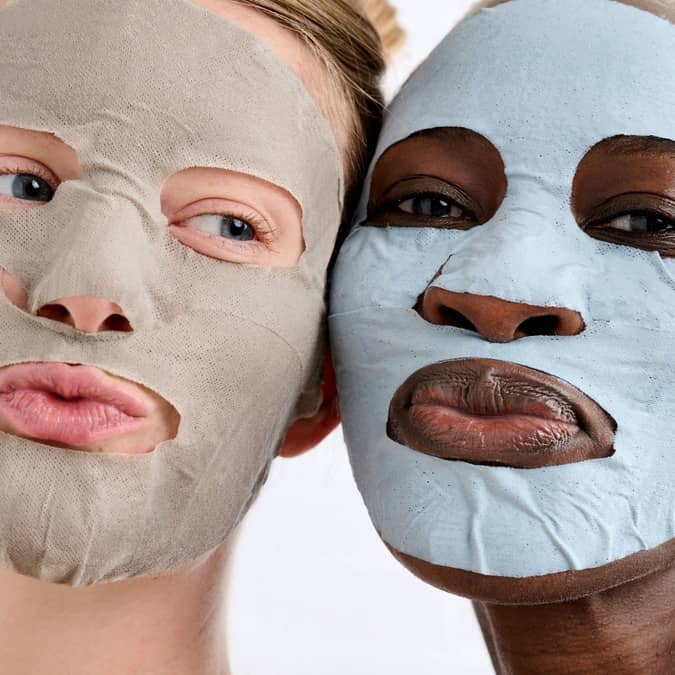 Two people wearing smartmud face masks on a white background